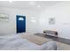 Bedroom with hardwood floors, a bench, and a blue accent door creates a welcoming and comfortable space at 709 S Parsons Ave, Deland, FL 32720