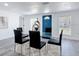 Bright dining room with modern table, decor and a view of the blue entry door at 709 S Parsons Ave, Deland, FL 32720