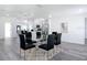 Open layout dining room featuring a glass table with views of the updated kitchen at 709 S Parsons Ave, Deland, FL 32720