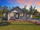 Charming single-story home featuring a front yard, cozy porch, and landscaped flower beds at 709 S Parsons Ave, Deland, FL 32720
