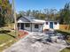 Stylish single-story home featuring two entry doors and a well-maintained front yard at 709 S Parsons Ave, Deland, FL 32720