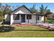 Charming single-story home featuring a front yard, cozy porch, and landscaped flower beds at 709 S Parsons Ave, Deland, FL 32720