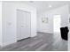 Hallway with white walls, gray flooring, and large closet space at 709 S Parsons Ave, Deland, FL 32720