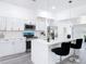 Spacious kitchen features white cabinetry, quartz countertops, stainless steel appliances, and a stylish breakfast bar at 709 S Parsons Ave, Deland, FL 32720
