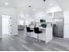 Bright kitchen with white cabinetry, stainless steel appliances, and a marble waterfall island at 709 S Parsons Ave, Deland, FL 32720