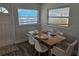 Bright dining area boasts wood table, seating for six, neutral walls, and natural light at 723 Dougherty St, New Smyrna Beach, FL 32168