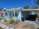 Bright blue home with a covered carport and well-maintained landscaping at 723 Dougherty St, New Smyrna Beach, FL 32168