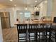 Modern kitchen features white cabinets, stainless steel appliances and bar seating at 723 Dougherty St, New Smyrna Beach, FL 32168