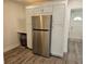 Kitchen showcases stainless LG refrigerator, white cabinets, luxury vinyl flooring, and a built-in nook at 723 Dougherty St, New Smyrna Beach, FL 32168