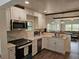 Open kitchen with stainless steel appliances, bright white cabinetry and a modern aesthetic at 723 Dougherty St, New Smyrna Beach, FL 32168