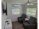 Living room featuring two leather recliners, luxury vinyl flooring, television, and mini-split AC at 723 Dougherty St, New Smyrna Beach, FL 32168