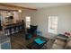 Open-concept living space with a cozy blue armchair and breakfast bar at 723 Dougherty St, New Smyrna Beach, FL 32168