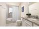Well-lit bathroom featuring a shower-tub combo, granite vanity, and neutral tiling at 7376 Oakmoss Loop, Davenport, FL 33837