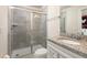 Modern bathroom featuring a tiled shower, granite vanity top, and ample space at 7376 Oakmoss Loop, Davenport, FL 33837