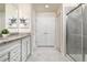 Bright bathroom featuring a spacious shower, double doors, and granite countertops at 7376 Oakmoss Loop, Davenport, FL 33837