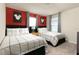 Charming bedroom showcasing twin beds, lively red accent wall, and Mickey Mouse décor at 7376 Oakmoss Loop, Davenport, FL 33837