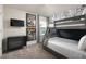 Bedroom features a bunk bed, comic wall decor, dresser and modern furnishings at 7376 Oakmoss Loop, Davenport, FL 33837