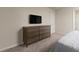 Cozy bedroom featuring a dresser, TV, plush carpet, and neutral wall color at 7376 Oakmoss Loop, Davenport, FL 33837