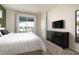 Bright bedroom offers an exterior view, a mounted TV, dresser and appealing decor at 7376 Oakmoss Loop, Davenport, FL 33837