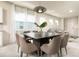 Dining room with modern decor, stylish lighting, and an open view to the living area at 7376 Oakmoss Loop, Davenport, FL 33837