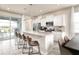 Modern kitchen featuring stainless steel appliances, granite countertops, with a view to the outdoor pool at 7376 Oakmoss Loop, Davenport, FL 33837