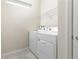 Convenient laundry room equipped with a washer and dryer, plus a shelf for storage at 7376 Oakmoss Loop, Davenport, FL 33837