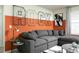 Comfortable living room boasts a modern sectional, stylish decor, and geometric wall art at 7376 Oakmoss Loop, Davenport, FL 33837
