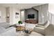 Cozy living room featuring modern decor, neutral color palette, and stylish furniture arrangement at 7376 Oakmoss Loop, Davenport, FL 33837