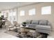 Inviting living room with a plush sofa, contemporary decor, and lots of natural light at 7376 Oakmoss Loop, Davenport, FL 33837