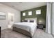 Comfortable main bedroom features a cozy bed, stylish decor, and an en-suite bathroom at 7376 Oakmoss Loop, Davenport, FL 33837