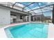 Enjoy this screened-in pool area, with a spa, lounge, and dining table; ideal for relaxation and entertainment at 7376 Oakmoss Loop, Davenport, FL 33837