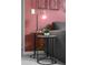 Side table featuring a plant, lamp and geometric art at 7376 Oakmoss Loop, Davenport, FL 33837