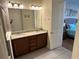 Bathroom featuring double sinks, a granite countertop vanity, and natural lighting at 7609 Brookhurst Ln, Kissimmee, FL 34747