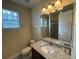 Well-lit bathroom featuring a granite countertop, and modern fixtures at 7609 Brookhurst Ln, Kissimmee, FL 34747