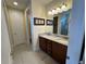 Bathroom boasts double sinks, granite countertops, framed art, and a glass-enclosed shower at 7609 Brookhurst Ln, Kissimmee, FL 34747