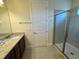 Bathroom features granite vanity, tiled floor, and glass-enclosed shower, creating a modern aesthetic at 7609 Brookhurst Ln, Kissimmee, FL 34747