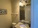 Bathroom with a granite countertop vanity, shower, and toilet at 7609 Brookhurst Ln, Kissimmee, FL 34747