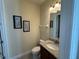 Cozy half-bathroom featuring a granite countertop, decor, and neutral color palette at 7609 Brookhurst Ln, Kissimmee, FL 34747