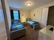 Bedroom featuring two twin beds with playful bedding, window, closet, and carpeted floor at 7609 Brookhurst Ln, Kissimmee, FL 34747