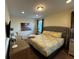 Spacious bedroom featuring a tufted headboard and a dresser with a mirror at 7609 Brookhurst Ln, Kissimmee, FL 34747