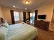 Comfortable bedroom featuring a queen-size bed and windows that let in natural lighting at 7609 Brookhurst Ln, Kissimmee, FL 34747