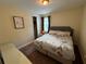 Bedroom with neutral walls, carpeted floor, and a bed with Paris themed covers and pillows at 7609 Brookhurst Ln, Kissimmee, FL 34747
