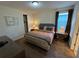 Comfortable bedroom with carpet, lamps, and decorative wall art at 7609 Brookhurst Ln, Kissimmee, FL 34747