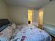 Bright bedroom with a Paris-themed comforter and white dresser, featuring natural light and neutral walls at 7609 Brookhurst Ln, Kissimmee, FL 34747