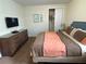 Bedroom featuring a bed, dresser, and closet at 7609 Brookhurst Ln, Kissimmee, FL 34747