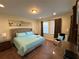 Cozy bedroom with a plush bed, neutral decor, and window with natural lighting at 7609 Brookhurst Ln, Kissimmee, FL 34747