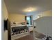 Bedroom featuring two sets of white bunk beds and a wall-mounted TV at 7609 Brookhurst Ln, Kissimmee, FL 34747