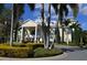 Grand clubhouse entrance with elegant landscaping and circular driveway at 7609 Brookhurst Ln, Kissimmee, FL 34747