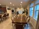 Large dining room with ample seating flows into the open-concept living area at 7609 Brookhurst Ln, Kissimmee, FL 34747