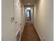 Long hallway with doors, neutral paint, and carpet flooring at 7609 Brookhurst Ln, Kissimmee, FL 34747